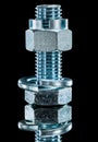 Construction nut screwbolt spring washer on black surface Royalty Free Stock Photo