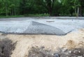 The construction of the Parking for coaches, laying of geomesh on soil before the asphalt pavement, Russia