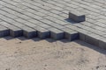Bricklayer places concrete paving stone blocks for building up a Sidewalk pavement Royalty Free Stock Photo