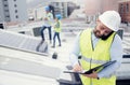 Construction, phone call and businessman writing checklist during building inspection on the roof. Engineer, architect Royalty Free Stock Photo