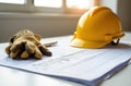 Construction planning with hard hat, gloves, and architectural blueprints. concept international workers day Royalty Free Stock Photo