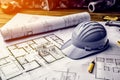 Construction plans with blue helmet and drawing tool. Royalty Free Stock Photo