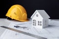 Construction plans with helmet, house and drawing tools on a table Royalty Free Stock Photo