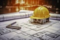 Construction plans with yellow helmet and drawing tool. Royalty Free Stock Photo