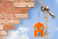 The construction of a prefabricated building - concept with tower crane and prefab leaning house Royalty Free Stock Photo