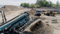 The construction process. Scene. Trucks carry materials for construction in an empty area behind which there is a river Royalty Free Stock Photo