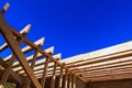 Construction progress of wooden roof structure under clear blue sky Royalty Free Stock Photo