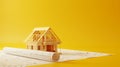construction project, house under construction on blueprint, yellow background with copy space Royalty Free Stock Photo