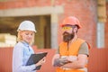 Construction project inspecting. Construction site safety inspection. Discuss progress project. Safety inspector concept Royalty Free Stock Photo