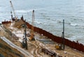 Construction of the promenade at sea, strengthening the sea coastline, special equipment on the beach Royalty Free Stock Photo