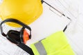 Construction protective clothing, labor protection, clipboard, hard hat and noise-absorbing headphones on a white background