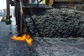 Construction and repair road. Technology and principles of joining road asphalt pavements using asphalt paver machine. Royalty Free Stock Photo