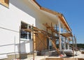 Construction or Repair of the Rural House with Skylights, Eaves, Windows, Fixing Facade, Insulation, Plastering and Painting House Royalty Free Stock Photo