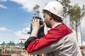 Construction of a residential area. Geodetic stakeout. Surveyor at a large construction site. A man with a tachometer during work