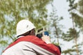 Construction of a residential area. Geodetic stakeout. Surveyor at a large construction site. A man with a tachometer during work