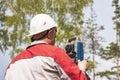 Construction of a residential area. Geodetic stakeout. Surveyor at a large construction site. A man with a tachometer during work