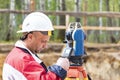 Construction of a residential area. Geodetic stakeout. Surveyor at a large construction site. A man with a tachometer during work