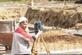 Construction of a residential area. Geodetic stakeout. Surveyor at a large construction site. A man with a tachometer during work