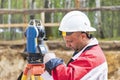 Construction of a residential area. Geodetic stakeout. Surveyor at a large construction site. A man with a tachometer during work