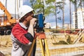 Construction of a residential area. Geodetic stakeout. Surveyor at a large construction site. A man with a tachometer during work Royalty Free Stock Photo