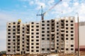 Construction of a residential building made of concrete blocks. View of the facade of unfinished building