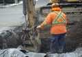 Construction worker shovel road repair drain sewer work excavation digger Royalty Free Stock Photo