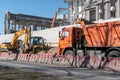 Construction and road machinery: an excavator and a dump truck at a construction site for the demolition of a building Royalty Free Stock Photo