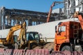 Construction and road machinery: an excavator and a dump truck at a construction site for the demolition of a building Royalty Free Stock Photo