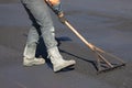 Construction road worker levelling fresh asphalt concrete Royalty Free Stock Photo