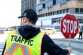 A construction road worker stopping traffic, holding a stop sign.