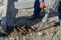Construction road workers using jackhammer digging the concrete surface Royalty Free Stock Photo