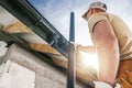 Construction Roof Worker Installing House Gutters Royalty Free Stock Photo