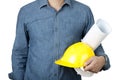 Safety Concept. Engineer wear blue shirt and hold yellow safety helmet and blue print on isolate background Royalty Free Stock Photo