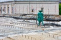 A construction sandblasting machine stands on a work platform for sandblasting of metal structures