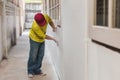 Construction sanding wall with sandpaper for a smooth finish during renovation work. Royalty Free Stock Photo