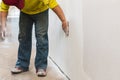 Construction sanding wall with sandpaper for a smooth finish during renovation work. Royalty Free Stock Photo