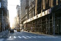 Construction scaffolding covers the buildings and sidewalks on 19th Street in Manhattan, New York City