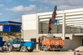 Construction of a ship with a truck unloading material for the structure Royalty Free Stock Photo