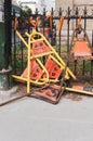 Construction signs and barricades piled on a fence in downtown Winnipeg, Manitoba, Canada