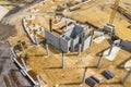 Construction site from above. Aerial view of workplaces in construction equipment, workers with heavy machinery. Industrial top