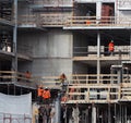 Construction site activity. Workers with work wears in a new building. Royalty Free Stock Photo