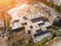 Construction site aerial view. Mall building base with solid concrete pillars. Heavy machinery and high tower crane Royalty Free Stock Photo