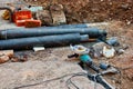 Construction Site with angle drive grinder lying in the dirt and bunch of waterpipes Royalty Free Stock Photo