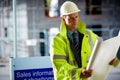 Construction site architect looking at a blueprint Royalty Free Stock Photo