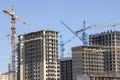 Construction site background. Hoisting cranes and new multi-storey buildings. tower crane and unfinished high-rise building. many