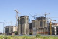 Construction site background. Hoisting cranes and new multi-storey buildings. tower crane and unfinished high-rise building.