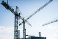 Construction site banner background. Construction industry and business concept. Cranes on a blue background. Royalty Free Stock Photo