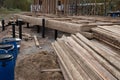 Construction site. The basis of a wooden house. Construction of the pile