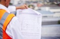 Construction site, blueprint and man reading document of building proposal in city from the back. Closeup design of Royalty Free Stock Photo