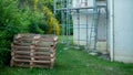 Construction site on a building facade and piled up wooden pallets